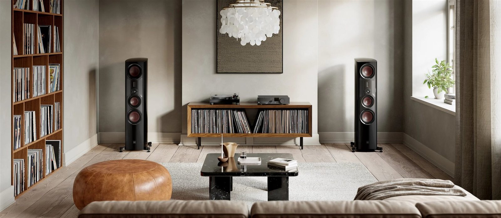 Floor-standing hi-fi speakers flanking a bright, book-lined living room