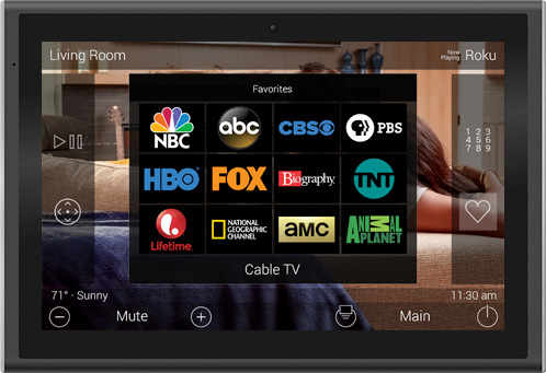 A wall-mounted touchscreen remote showing a Favorites screen with cable and streaming channel icons for the living room